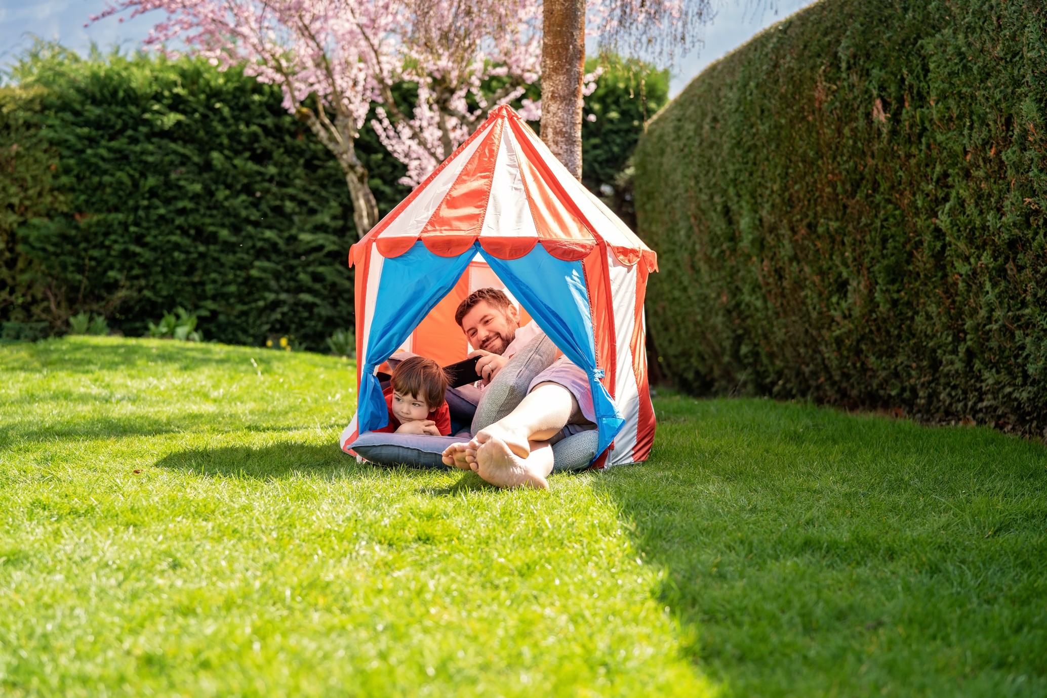 toddler and dad in tent castle in garden