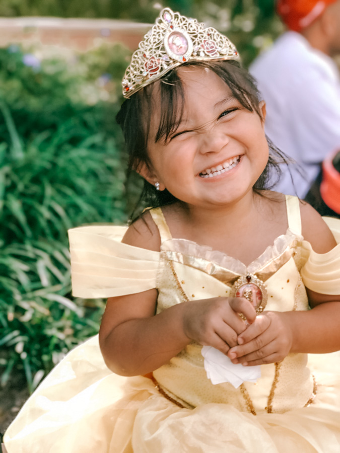 toddler in princess dress smiling