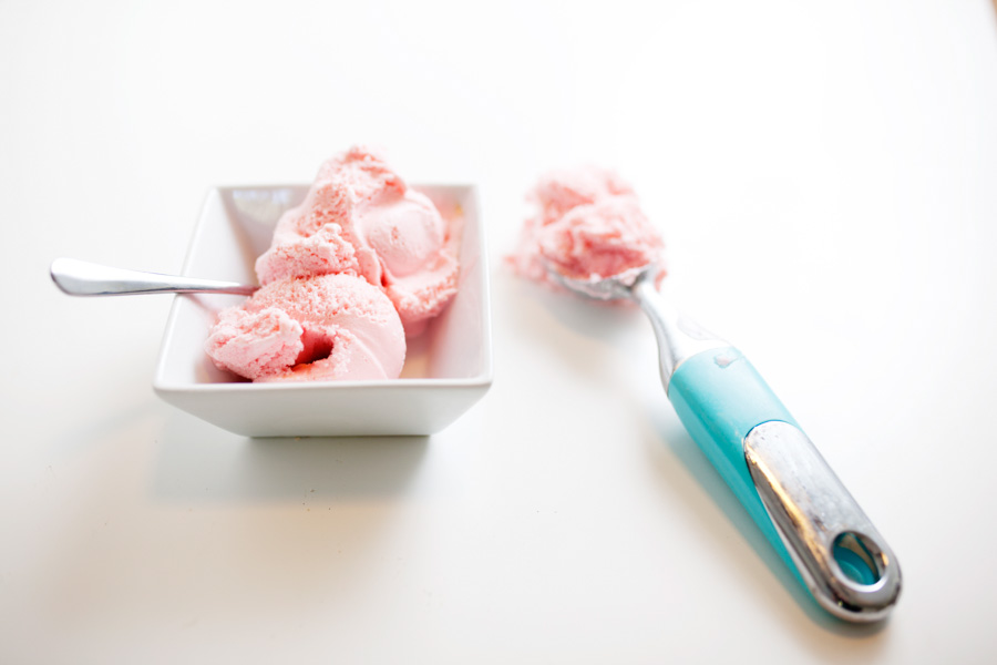 pink ice cream in white bowl